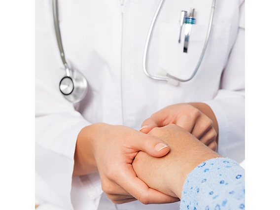 picture of a nurse's hands holding the hand of a patient