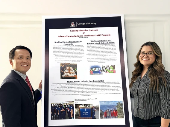 Dean and Samantha Chai standing around her presentation board.