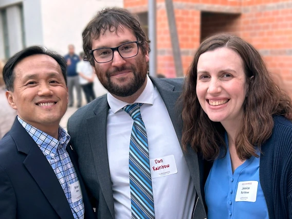 Jessica Rainbow with her husband and dean of college outside.