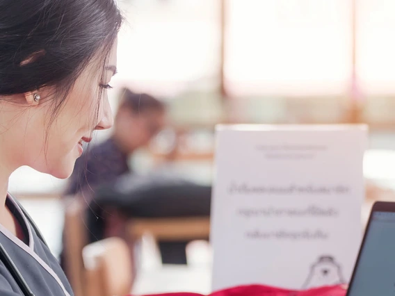 Woman studying on laptop.