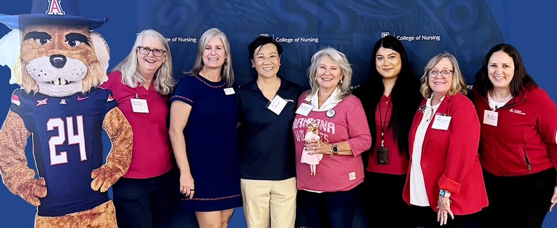Group of alumni on a blue background.