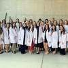 DNP students wearing white coats standing outside in groups