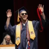 Kyle Breske celebrates as he walks across the stage to be pinned during the University of Arizona College of Nursing spring 2025 convocation.
