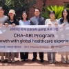 Dean Ahn and visiting students from South Korea holding sign outside