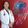 Shu-Fen Wung standing infront of a red background with AI sysmbols on it.
