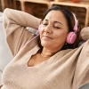 Woman relaxing on couch listening to music