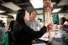 Kyra Johnson looking at a muscle model in pre-nursing class